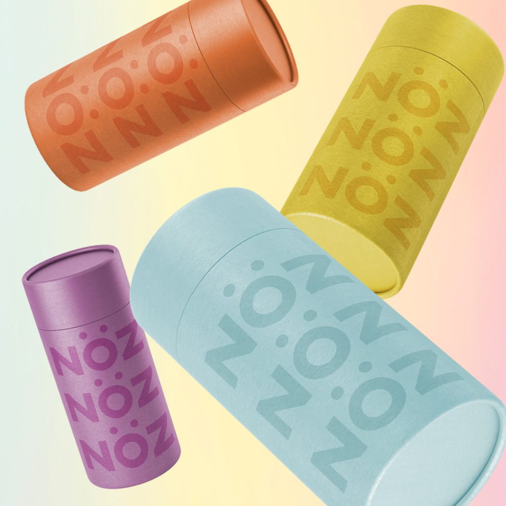 All four of Nöz's sunscreen sticks in orange, yellow, purple and light blue. 